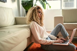Woman working alone remotely from her living room 