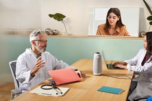 Hybrid team meeting in medical office setting 